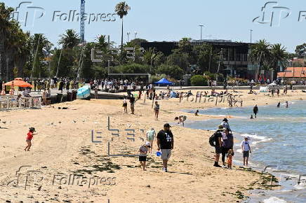 People relax on Melbourne St Kilda beach