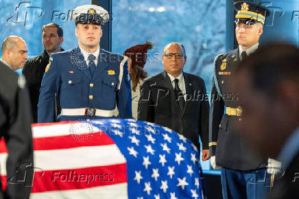 Guatemalan Consul General to Atlanta Erwin Rudy Roberto Archila, views the casket of former President Jimmy Carter as he lies in repose at the Jimmy Carter Presidential Library and Museum in Atlanta