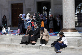 Women attend the Friday prayers at the courtyard of the Blue Mosque in Istanbul