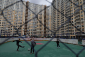 Children play soccer in the yard of an apartment block in Saint Petersburg