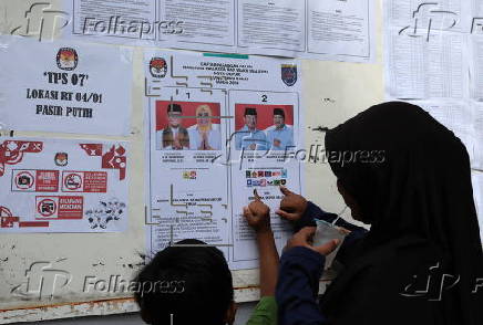 Voters cast their ballows in regional government elections in Indonesia