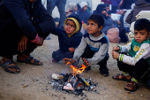 Displaced Palestinians wait to be allowed to return to their homes in northern Gaza, in the central Gaza Strip