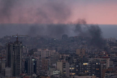 Smoke rises in Beirut's southern suburbs during sunset, after Israeli air strikes, amid ongoing hostilities between Hezbollah and Israeli forces, as seen from Sin El Fil