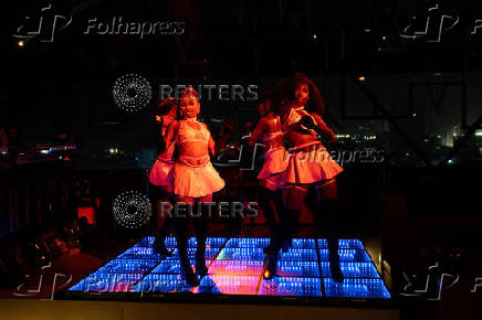 Performers dance inside a night club in Lagos