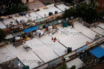 A view shows roofs of shanties painted with solar reflective paint in a slum area in Ahmedabad