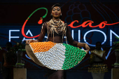 A model presents a dress covered of chocolates packaged in the colours of the Ivorian flag during the ninth edition of the National Cocoa and Chocolate Days in Abidjan