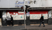 People walk along a street, in Damascus