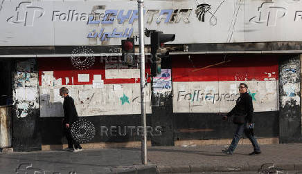 People walk along a street, in Damascus