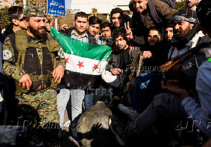 People gather in Umayyad Square after Syria's Bashar al-Assad was ousted in central Damascus