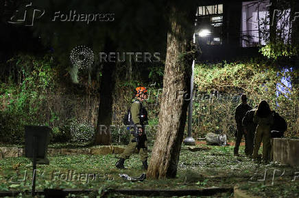 Israeli emergency services work at the scene of a missile strike, in Jaffa, south of Tel Aviv