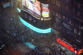 People gather at Times Square to watch the ball drop on New Year's Eve in New York City