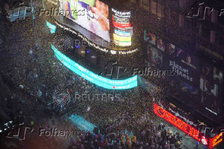 People gather at Times Square to watch the ball drop on New Year's Eve in New York City