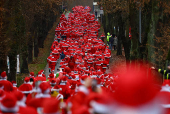 People dressed as Santa Claus run through the streets in Michendorf