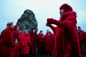 Revellers attend winter solstice celebrations during sunrise at Stonehenge stone circle near Amesbury