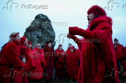 Revellers attend winter solstice celebrations during sunrise at Stonehenge stone circle near Amesbury