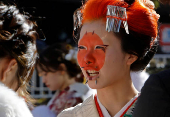 Kimono-clad young women stand at the venue for their Coming of Age Day celebration ceremony in Yokohama