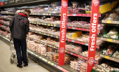 FILE PHOTO: Shopper walks along the meat aisle inside an ALDI supermarket near Altrincham