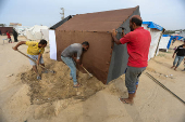 Palestinians set up tents for displaced people amid fears of Israeli ground offensive on Rafah, in Deir Al-Balah in the central Gaza