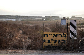 A Hebrew sign shows the direction to a military base, the scene of where a drone from Lebanon attacked Israel, amid cross-border hostilities between Hezbollah and Israel, in Binyamina