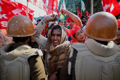 Farmers from the northern state of Uttar Pradesh shout slogans as they protest to demand better compensation for their land, in Noida