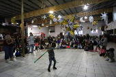 Migrants participate in a Posada ahead of Christmas, in Tijuana