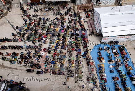 Gaza displaced Palestinians perform Friday prayer near mosque ruins in Rafah