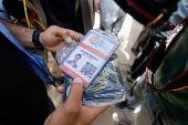 A person holds a document of aid worker Saifeddin Issam Ayad Abutaha, who was killed in an Israeli strike along with other foreign workers from the World Central Kitchen (WCK), in Rafah, southern Gaza Strip