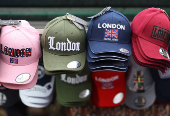Souvenir caps are displayed at a street retail stand in London