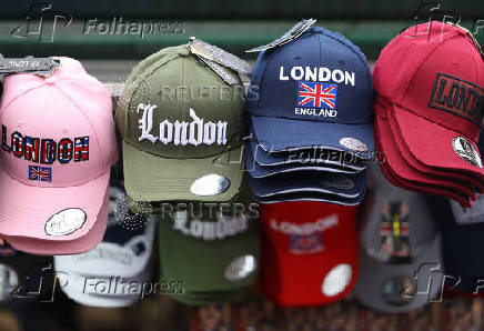 Souvenir caps are displayed at a street retail stand in London