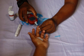 A person receives a free blood sugar test during a campaign to mark the World Diabetes Day in Dhaka