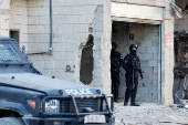 Palestinian security forces patrol amid clashes with militants at the camp in Jenin