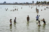 Beachgoers enjoy St Kilda beach