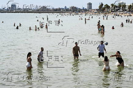 Beachgoers enjoy St Kilda beach