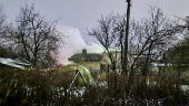 Smoke billows following a DHL cargo plane crash in Vilnius