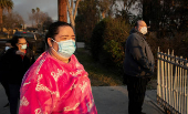 Elizabeth Jimenez stands outside the gate of her home that was destroyed by the Eaton Fire in Altadena