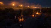 Migrants encircle fire to stay warm as they search for entry point into U.S. from bank of Rio Grande river