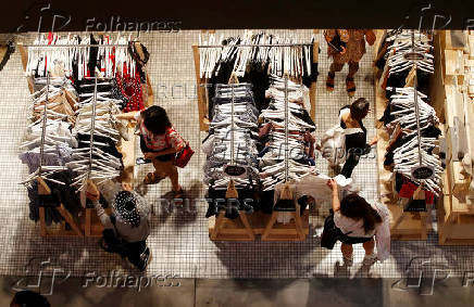 FILE PHOTO: Women shop for clothes on a store in a shopping mall in Sydney