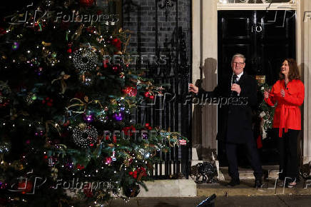 British Prime Minister Starmer and his wife switch on the Downing Street Christmas tree lights, in London