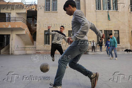 Students in a classroom after authorities announced the reopening of schools, in Damascus