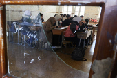 Students in a classroom after authorities announced the reopening of schools, in Damascus