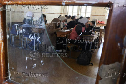 Students in a classroom after authorities announced the reopening of schools, in Damascus