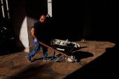 Maldonado, with the Department of Citywide Administrative Services, wheels broken concrete away from the Brooklyn Bridge subway station area in New York City