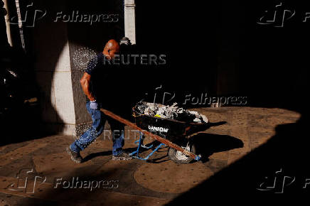 Maldonado, with the Department of Citywide Administrative Services, wheels broken concrete away from the Brooklyn Bridge subway station area in New York City