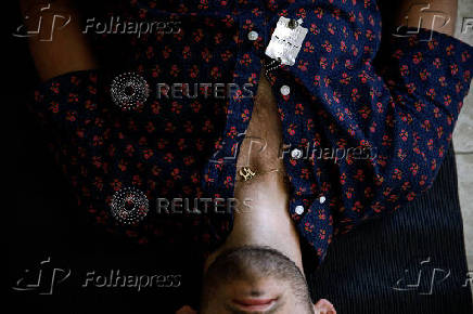 A photographer who survived the deadly October 7 attack by Hamas on the Nova festival, lies on a mat at an event he designed to bring together and humanise people who survived the attack, in Caesarea