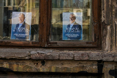 FILE PHOTO: Posters of presidential candidate Calin Georgescu hang on a window in Bucharest, Romania