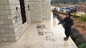 Palestinians check damage to a mosque burned by Israeli settlers in the West Bank