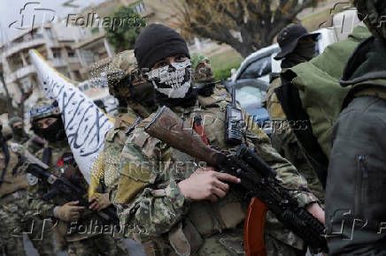 FILE PHOTO: Khaled Brigade, a part of Hay'at Tahrir al-Sham (HTS), hold a military parade, in Damascus