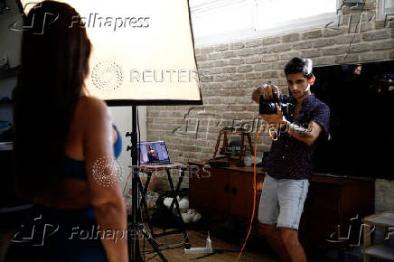 A Nova festival survivor and gym instructor stands for a portrait, in Caesarea