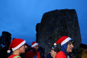 Revellers attend winter solstice celebrations during sunrise at Stonehenge stone circle near Amesbury