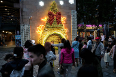 People wait to pose for pictures at a Christmas theme park in New Taipei City